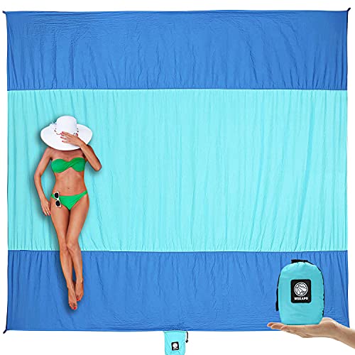 Woman laying on a large beach blanket