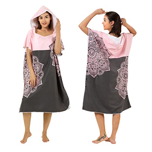 Woman wearing a pink and brown poncho to changes clothes at the beach