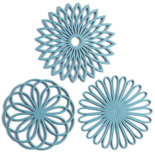 A set of three blue trivets in floral shapes