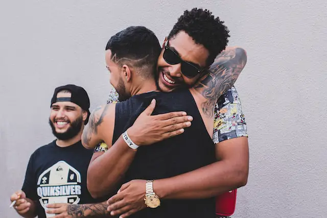 Two mean giving each other hugs