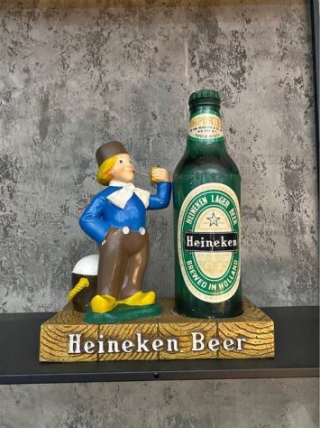 A heineken beer statue and glass