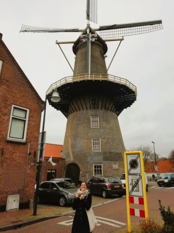 Woman standing in front of a Windmill