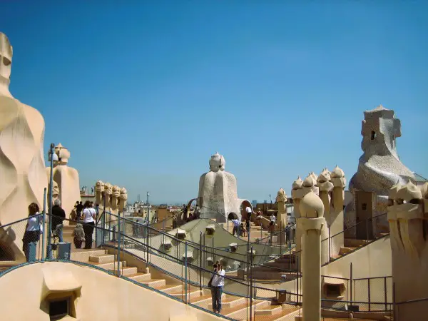A woman taking a photo on a rooftop in Barcelona