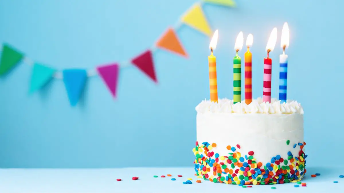A birthday cake with a blue background