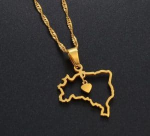 A golden necklace with a pendant in the shape of the map of Brazil