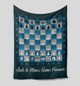 A blanket with a chess print and a personalized message