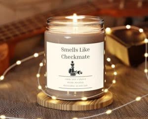 A candle with the label "Smells lik checkmate"
