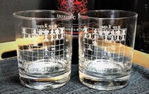Two whiskey glasses with a chessboard etched