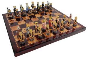 A chess board with pieces that look like cats and dogs