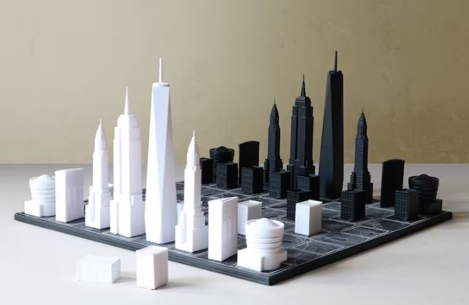 A chess board with pieces that resemble buildings from New York City