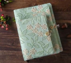 Three notebooks covered in silk from China