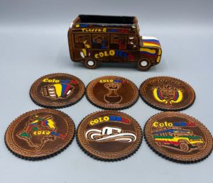 A set of coasters in Colombia-themed with a miniature Colombia chiva bus