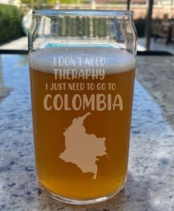 A beer glass with the text "i don't need therapy, I just need to go to Colombia"