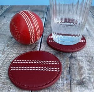 A cricket ball, as glass and coasters made from cricket ball material