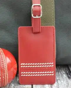 A luggage tag made from cricket ball material