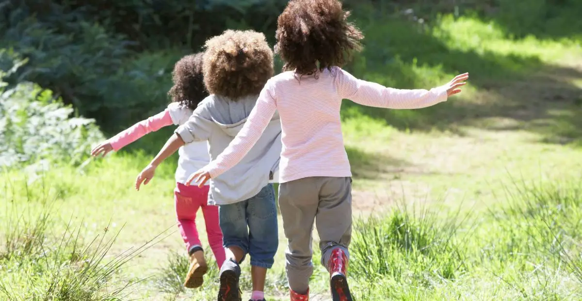 Three children playing outdoors