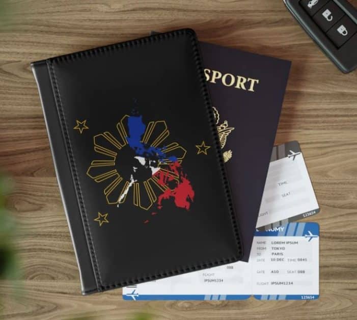 A black passport cover with a symbol from the Philippines