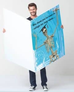 Man holding a giant graduation card with a funny text "You know you've been in college too long when...