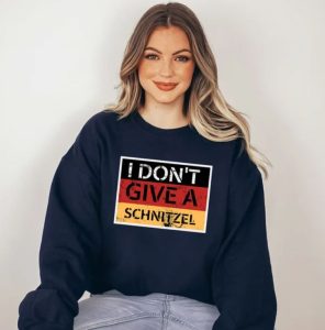 A woman wearing a Germany-themed hoodie with "I don't give a schnitzel"