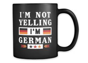 A balck coffee mug with the funny text "I'm not yelling, I'm German"