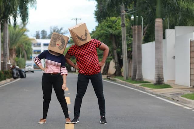 Two people with cardboards on their heads