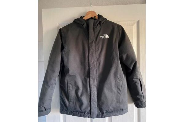 A black rain jacket from the brand The North Face