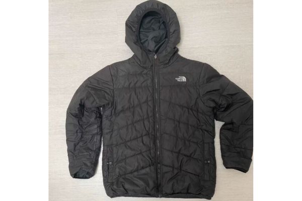 A black puff jacket from the brand The North Face