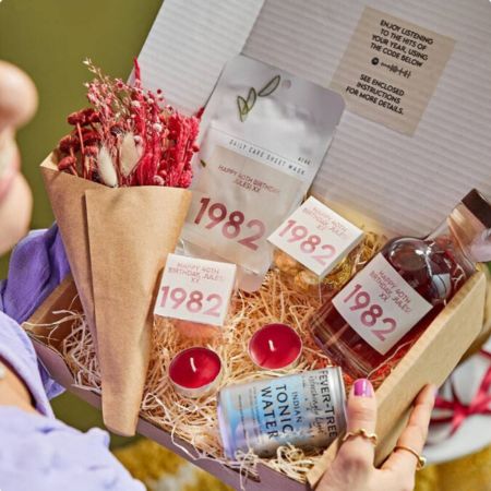A gift basket with a personalized gin bottle