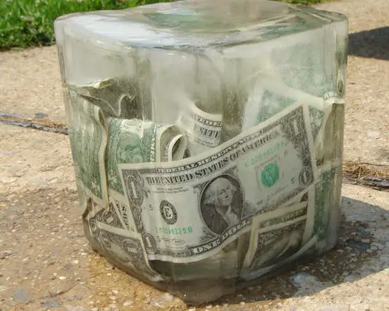 Ice cube with cash frozen inside