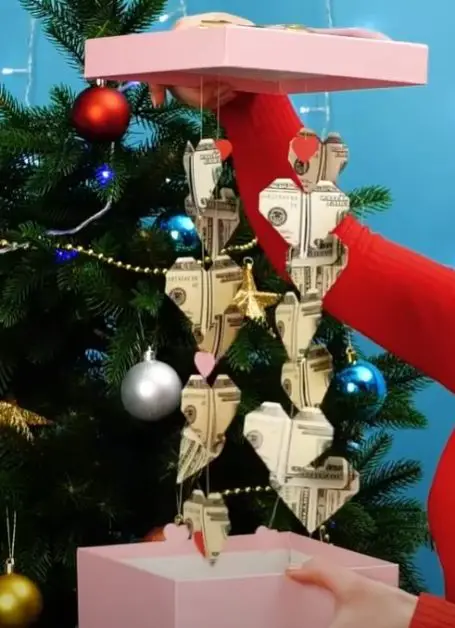 Box with money hearts hanging from strings