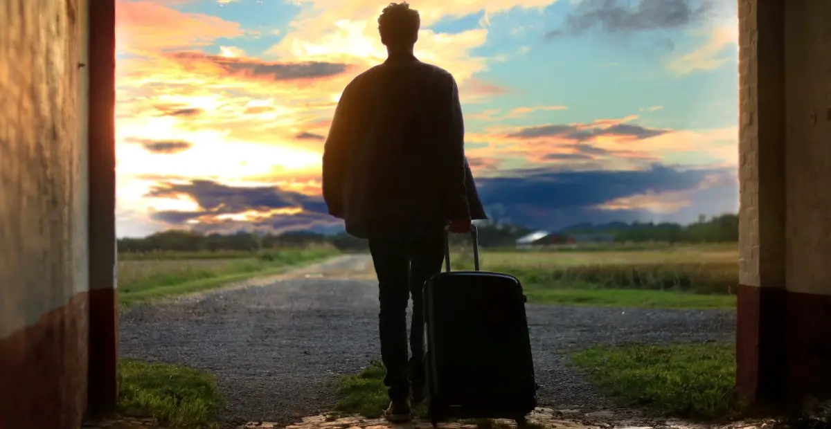 Person walking away with suitcase