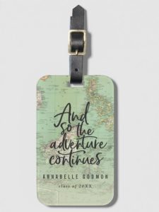Luggage tag with the world map, class of 2023, a name and the quote "and so the adventure continues"
