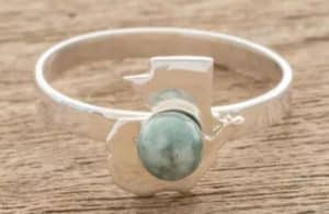 A silver ring with a jade