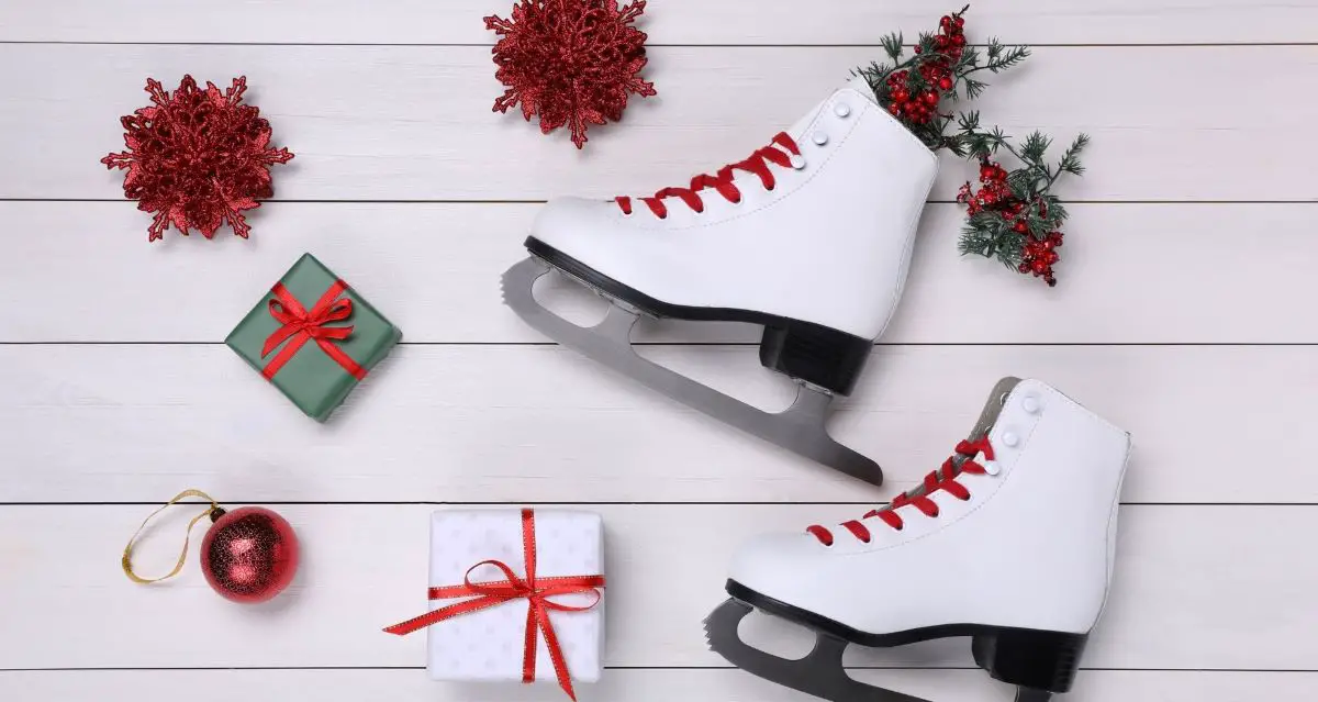 A pair of figure skates with Christmas ornaments and gifts
