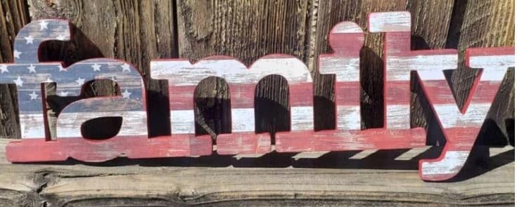 A wooden sign with "family" in the colors of the US flag