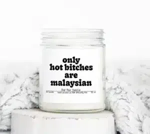 A wax candle with a label that reads "Only hot b*tches are Malaysian"