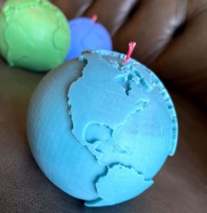 A blue canlde with the world map
