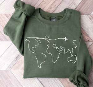 A green sweatshirt with a print of the map of the world drawn in one line