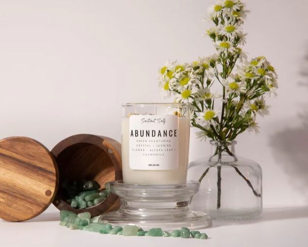 A candle with a label of "abundance"