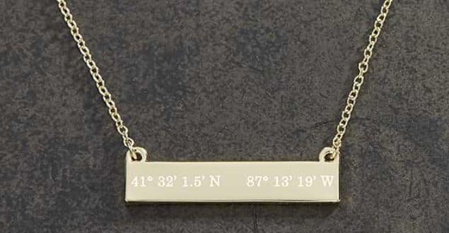 A necklace with a pendant with coordinates