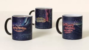 Three coffee mugs with the names of three national parks and a starry night
