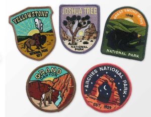 Five embroidered patches of different national parks