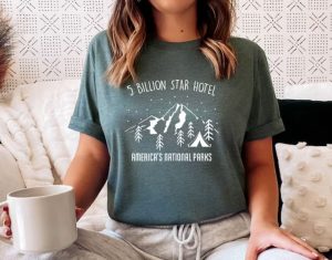 A woman wearing a shirt with "5 billion star hotel, America's national parks"