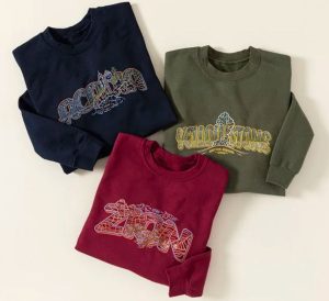 Three sweatshirt in different colors with the names of different US national parks