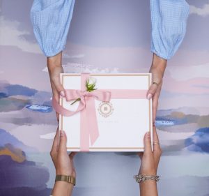 Two people holding a gift