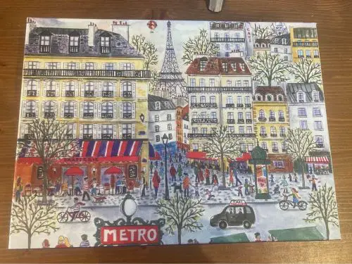 The box of a jigsaw puzzle with a picture from Paris