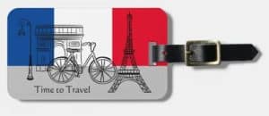 Luggage tag with "time to travel" and typical French things and the colors of the French flag