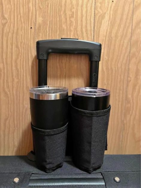 A luggage handle with a holder for two coffee cups
