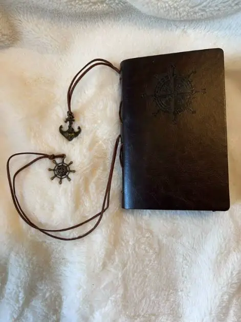 A black journal with a compass
