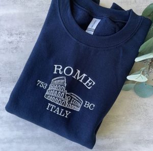 A blue sweatshirt with Rome and an icon of the Colosseum